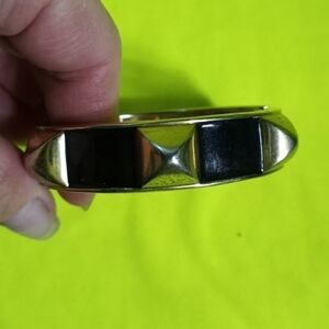 Goldtone pyramids Black hinged bracelet